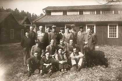 John Lund with workers and dog outside the office (old factory).