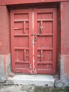 Door locked with beam and padlock